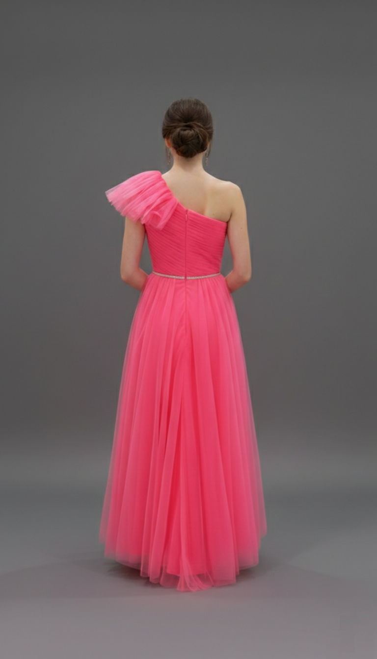 The back of a watermelon pink one-shoulder formal dress showing the layered tulle high-low skirt with a graceful U-shaped hem. Professional studio shot for Trendy Angels Boutique, 533 Sydney Rd Brunswick. Call 04 19 19 19 09 for sizing.