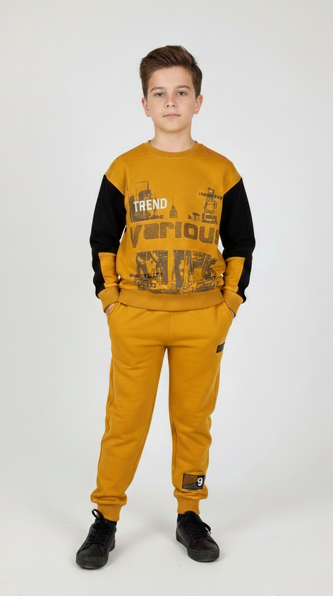 Young boy in a mustard yellow and black urban outfit featuring high-quality, soft-on-skin fabric; a fleece-free set ideal for active play or lounging from our Melbourne boutique.
