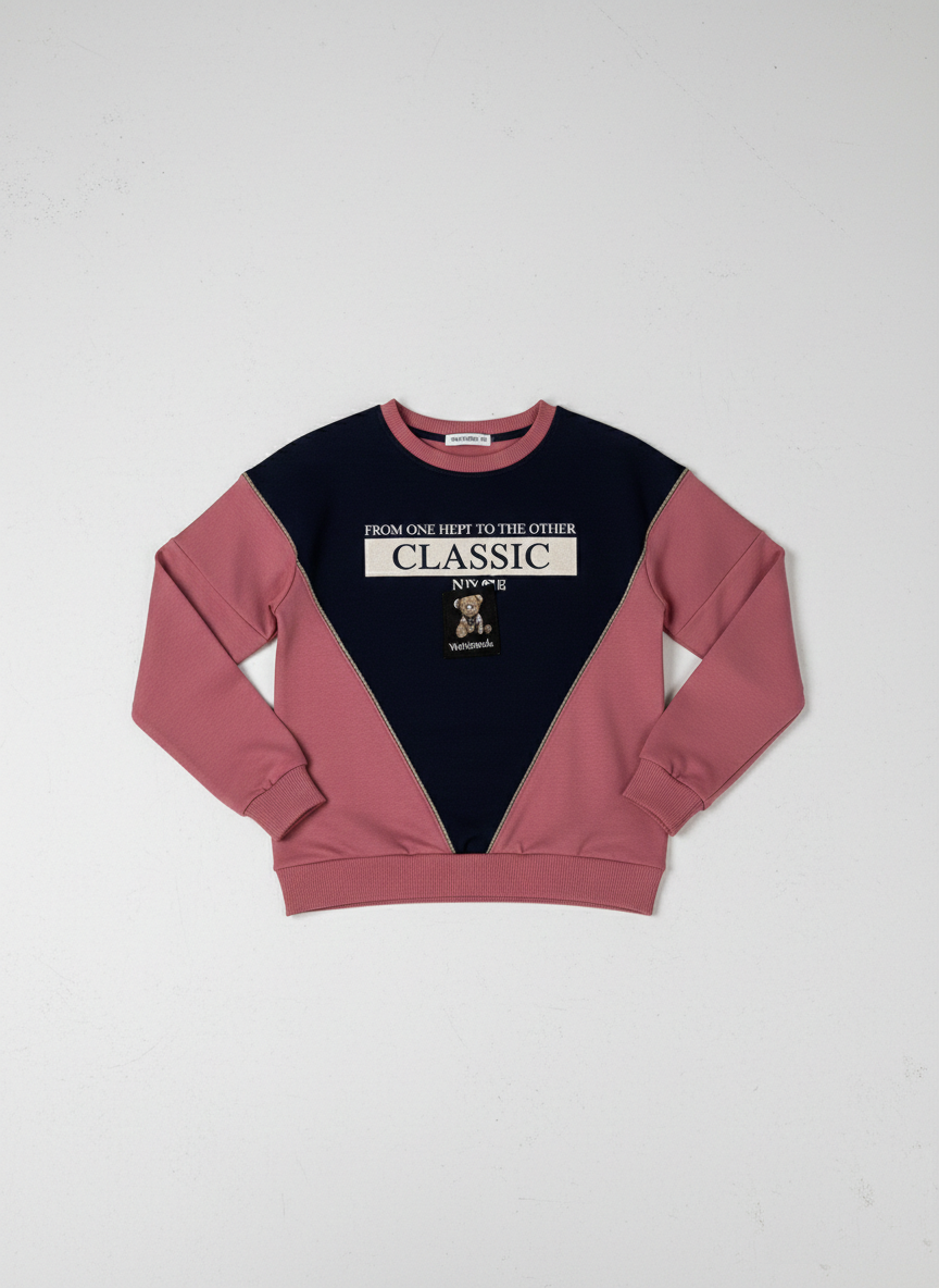 Close-up of the Dusty Rose and Navy Blue "Classic" graphic sweatshirt featuring white embroidered text, a teddy bear patch, and long sleeves with a relaxed fit from Trendy Angels Boutique.
