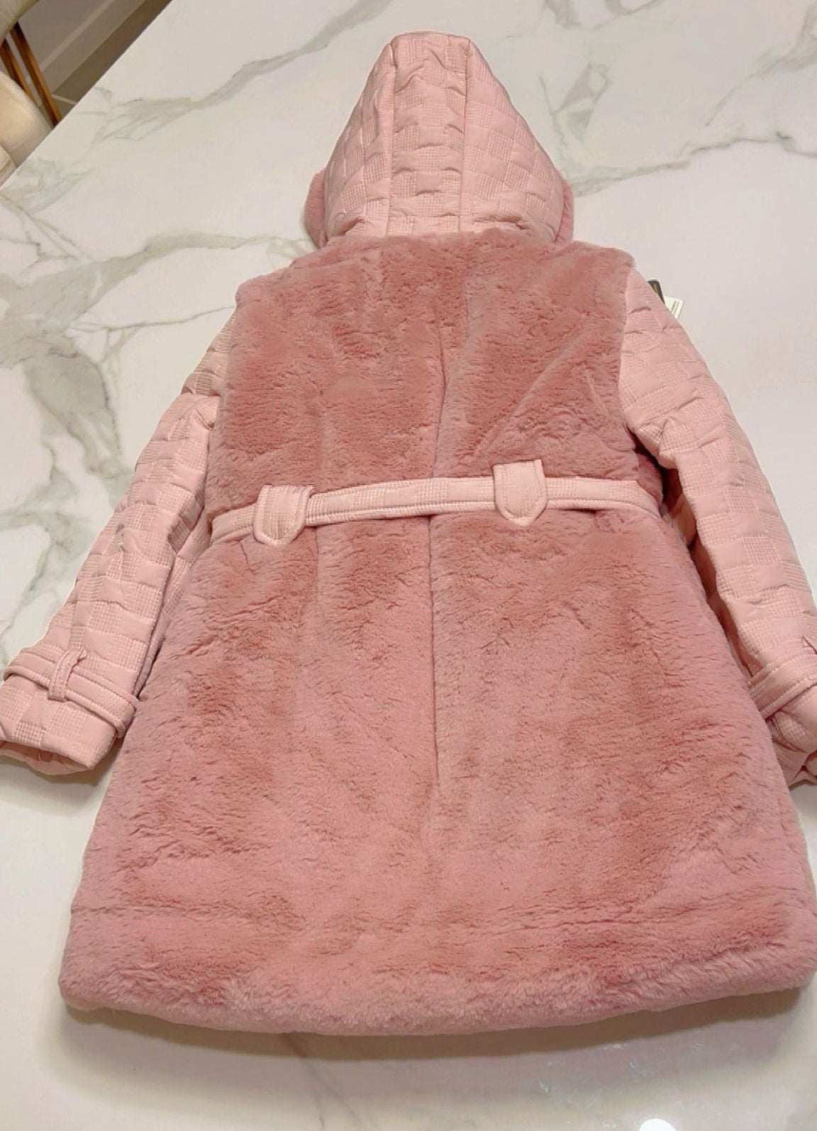 Flat-lay back view of the Isabella girls' rose pink faux fur coat, showing the plush fur back panels, the continuation of the quilted texture on the hood and sleeves, and the neat belt loop details