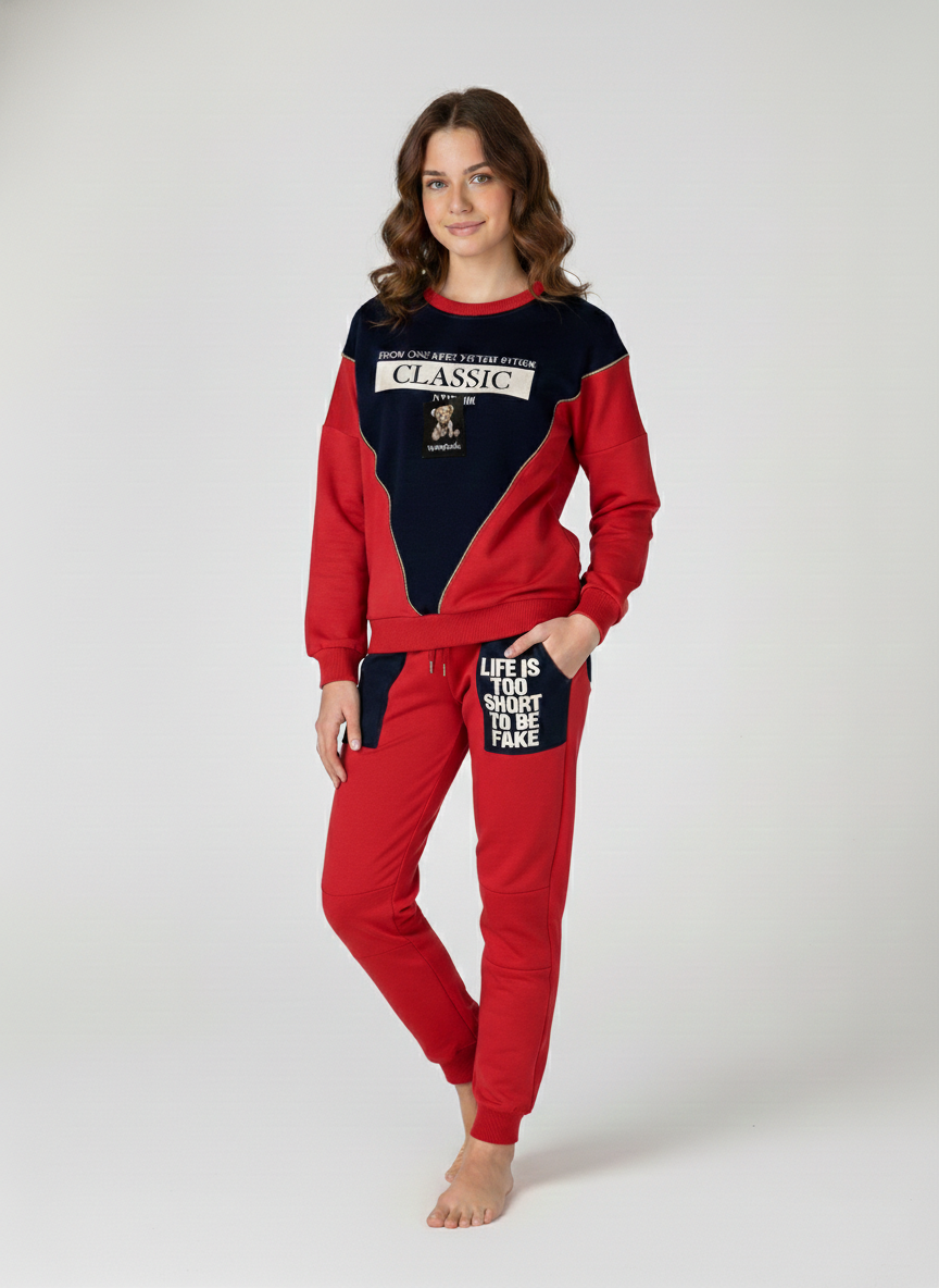 Full-length view of a woman wearing a vibrant red and dark navy "Classic" lounge set featuring graphic patches and the "Life is too short to be fake" pocket detail at Trendy Angels Boutique in Brunswick.