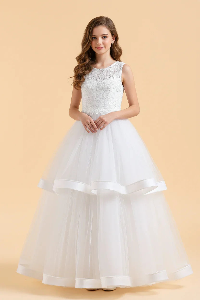 A stunning sleeveless white flower girl dress featuring an intricate lace bodice and a voluminous two-tier tulle skirt with satin ribbon edging.