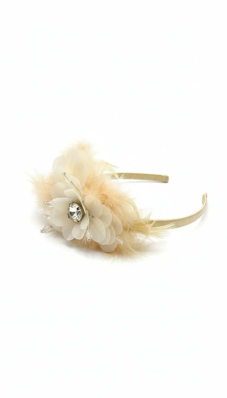 Exquisite couture hairband featuring delicate peach 3D petals and a central crystal jewel. Hand-crafted to complement luxury celebration wear. Available at 533 Sydney Rd, Brunswick, Melbourne. Call 04 19 19 19 09 for details