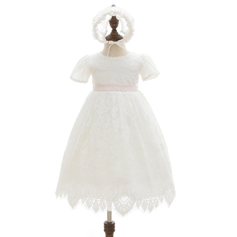 Front view of a baby girl's white floral lace baptism dress with a pink ribbon sash and matching full lace bonnet displayed on a mannequin at Trendy Angels Boutique, 533 Sydney Rd Brunswick Melbourne.