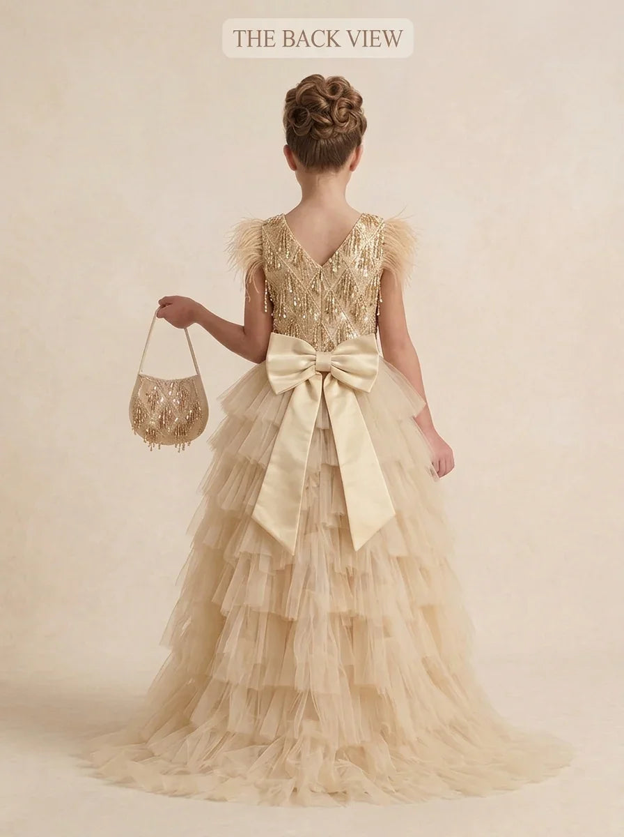 Back view of girls luxury gold sequin formal party dress featuring a long detachable tulle train and large satin bow for Melbourne events.