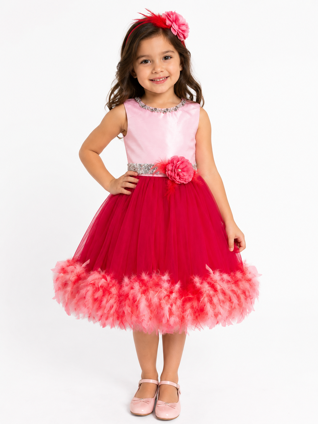 Little girl model smiling wearing luxury pink and red formal princess dress with matching flower headband front view