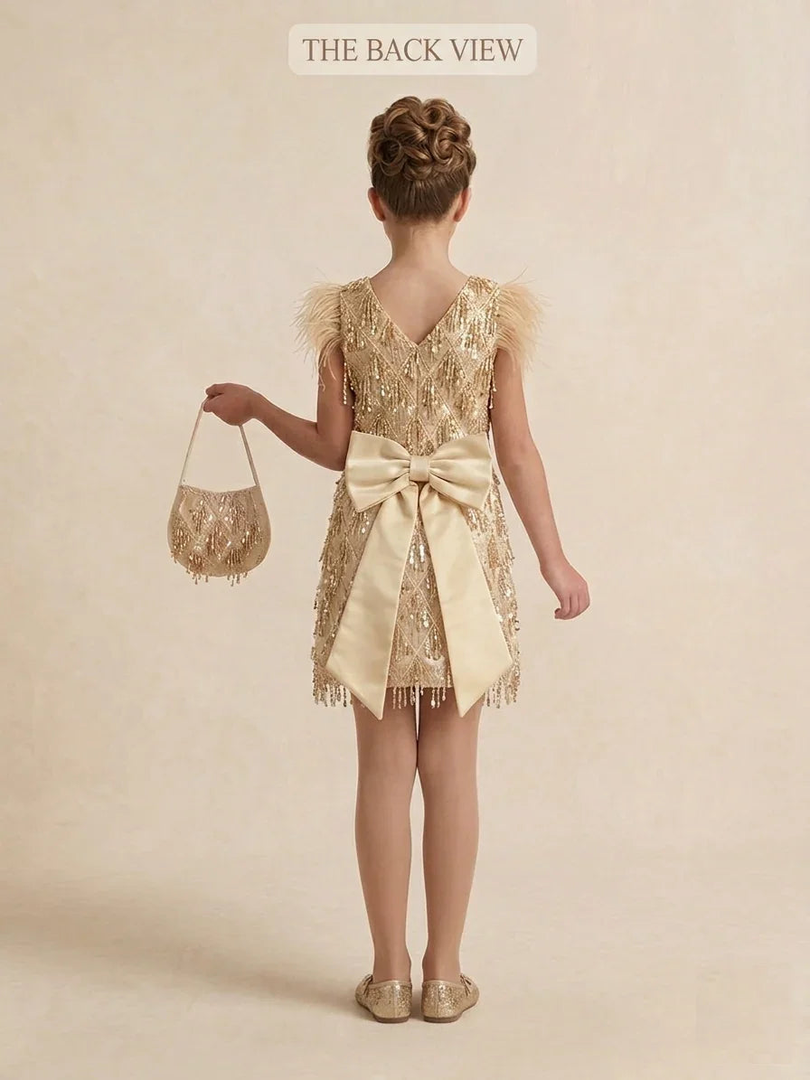 Back view of girls short gold sequin formal dress with large satin bow accent, designed for luxury children's partywear near Merri-bek council areas.
