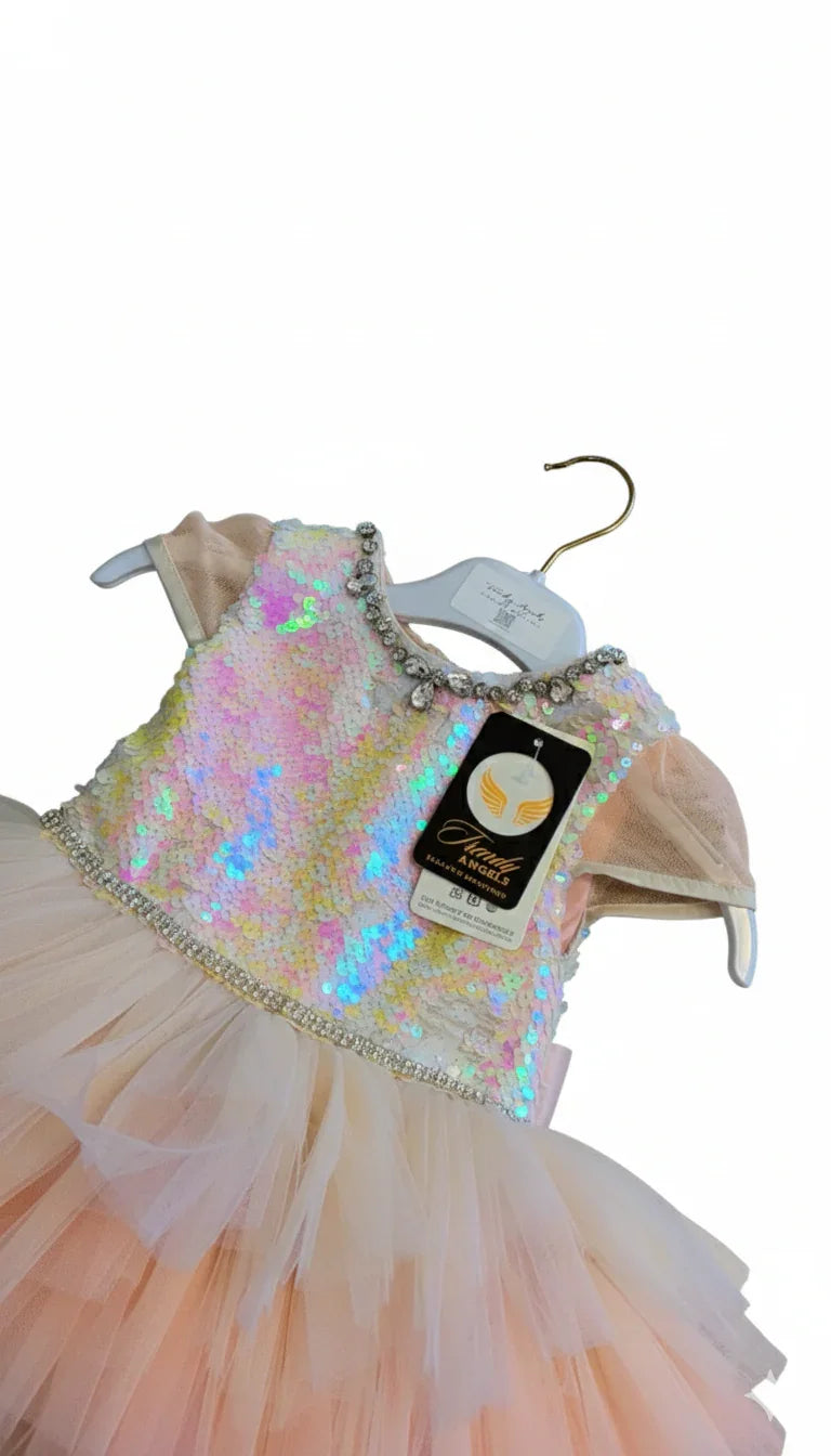 Children's sequined dress on a hanger with a visible brand tag.