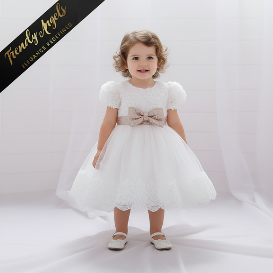 Toddler and little girl wearing a white tutu dress with a gold sequin bow, perfect for formal parties and weddings at Trendy Angels Boutique.
