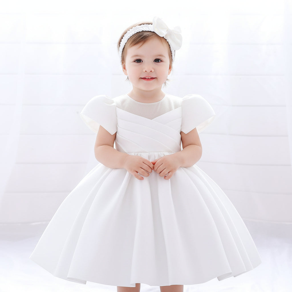 White satin flower girl dress with caped sleeves and back bow tie - Luxury holy communion and baptism gown for girls at Trendy Angels Boutique Melbourne.